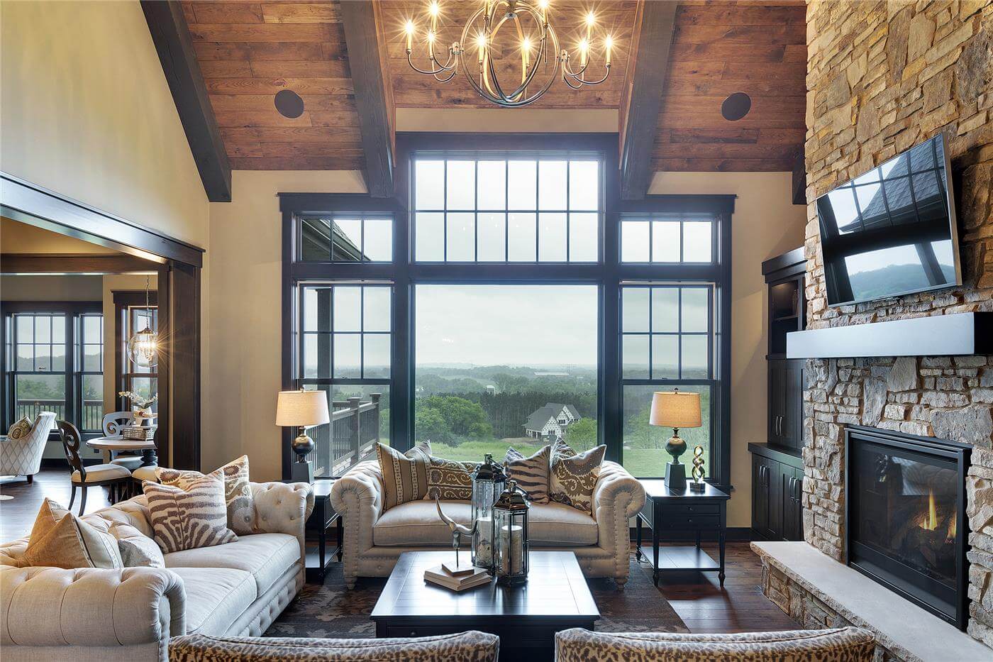 Cozy family room with large windows overlooking green landscape