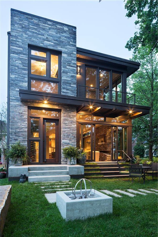 Backyard of modern house with large windows and doors