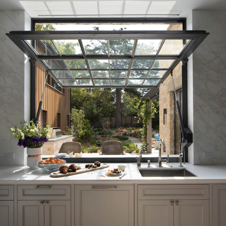 Kitchen with large swiveling window open