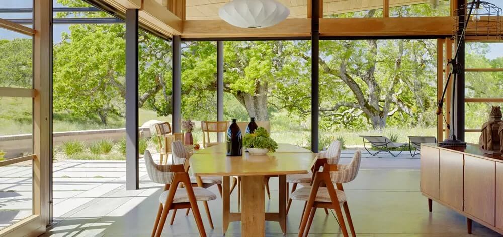 Country retreat interior with swiveling doors and windows